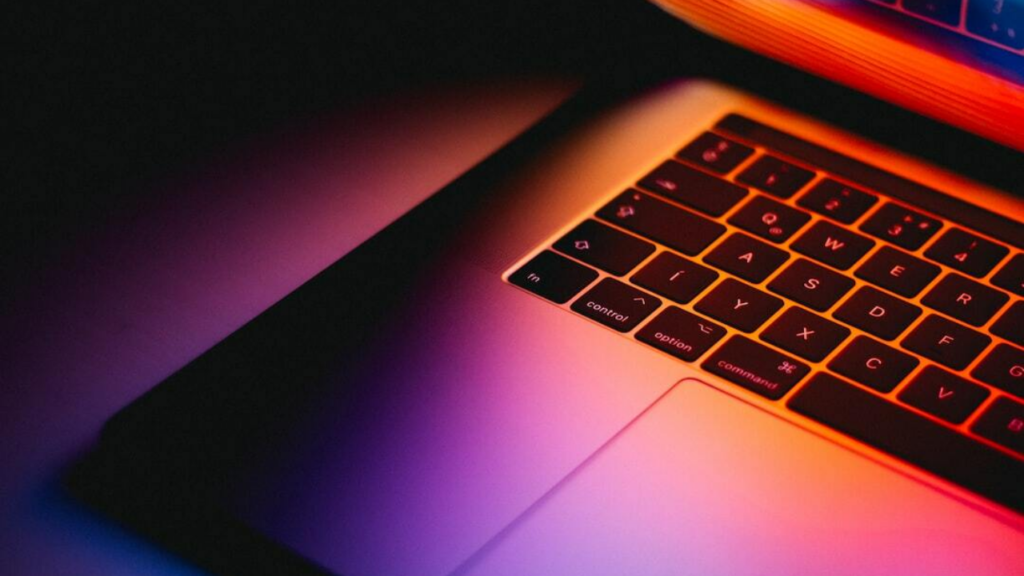 A businessperson looking at a laptop with a graph showing the success of content marketing